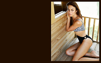 Olga Kurylenko, black lower with large ring attachment, sexy swim suit, brunette, leaning by window, wood hutch, leopard skin pattern top HD wallpaper