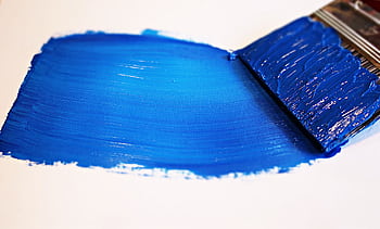 Close-up of a vivid blue brushstroke applied to a white canvas using a paintbrush. HD wallpaper