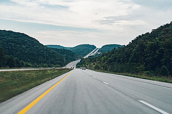 A que highway running through lush green hills, ideal for road trips. HD wallpaper