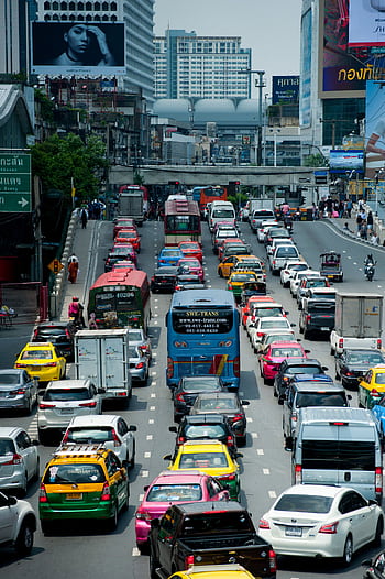 A bustling scene of cars and buses in a traffic jam on Bangkok's expressway. HD phone wallpaper