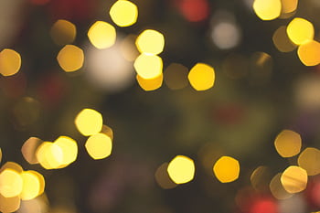A captivating display of warm bokeh lights forming an abstract festive background. HD wallpaper
