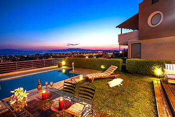 Experience a tranquil sunset by the pool with stunning views in Greece. HD wallpaper