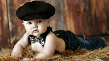 Cute Baby Boy Is Lying Down On Fur Cloth Wearing Black Hat And Blue Jeans Cute HD wallpaper
