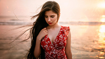 Girl Model Is Looking Down Wearing White Flowers Printed Red Dress Standing In Blur Ocean Background Girls HD wallpaper