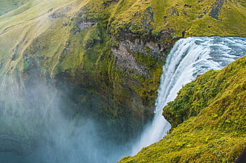Stunning view of Skogafoss waterfall with lush greenery in Iceland. HD wallpaper