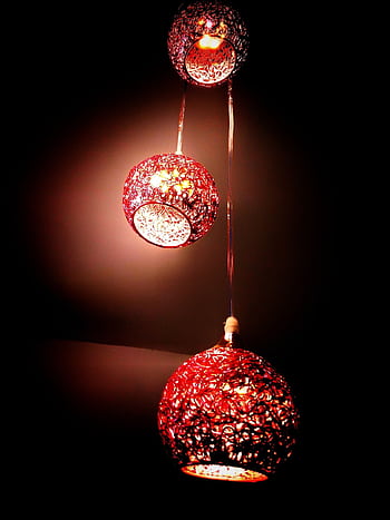 Three red lanterns casting a warm, ambient glow, perfect for festive indoor decoration. HD phone wallpaper