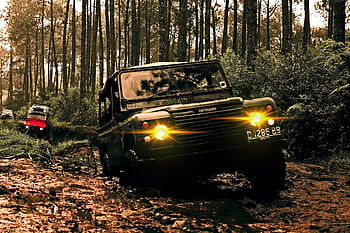 Rugged SUVs navigate muddy terrain in Parongpong, Indonesia forest. HD wallpaper
