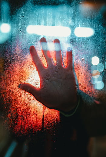 A dramatic depiction of a hand pressed against a foggy, illuminated window. HD phone wallpaper