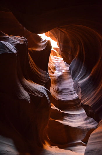 Explore Antelope Canyon's breathtaking sandstone formations in a captivating play of light and shadow. HD phone wallpaper