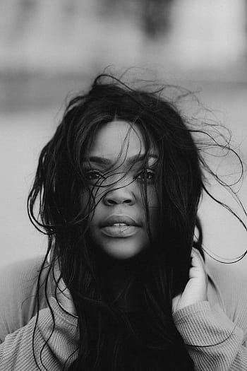 Black and white portrait of a woman with flowing hair and captivating gaze. HD phone wallpaper