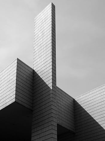 Black and white of a futuristic skyscraper with geometric lines, capturing Hong Kong's modern architecture. HD phone wallpaper