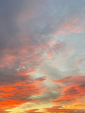 Colorful sunset sky with illuminated clouds creating a dramatic and serene atmosphere. HD phone wallpaper