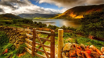 gate in a fence on a hill above a lake, hills, gate, fence, clouds, srones, lake HD wallpaper