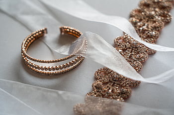 Close-up of luxurious rose gold bracelet and lace, ideal for brides. HD wallpaper