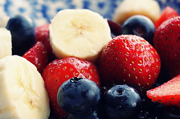 Close-up of fresh bananas, strawberries, and blueberries. Perfect for health and diet themes. HD wallpaper