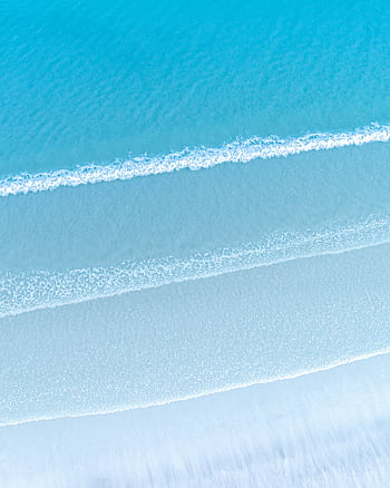 Serene aerial view of turquoise ocean waves lapping a pristine sandy shore at Callala Beach, Australia. HD phone wallpaper