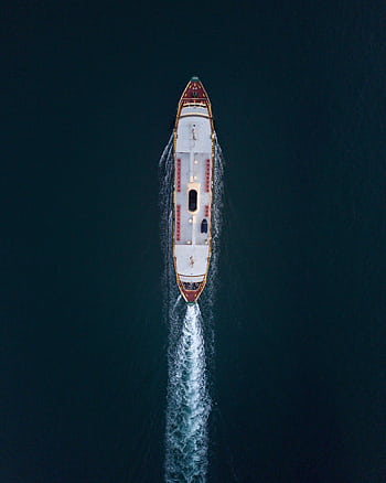 Top-down view of a ferry cruising through Sydney waters, creating rippling waves. HD phone wallpaper