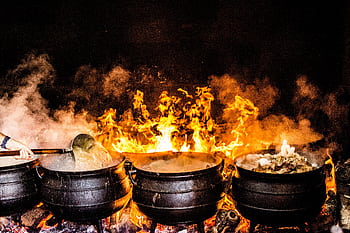 Vibrant outdoor cooking scene with large pots over open flame, showcasing traditional Açores methods. HD wallpaper