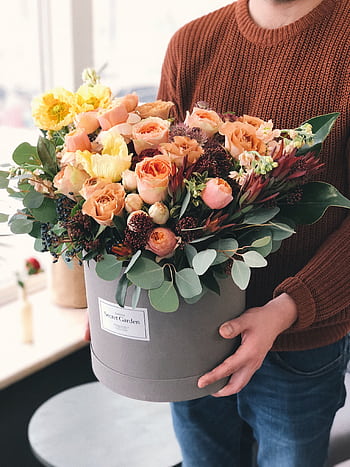 Stylish bouquet of mixed flowers in a round box, perfect as a gift or decoration. HD phone wallpaper
