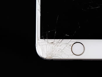 Detailed of a cracked smart screen highlighting damage to the device. HD wallpaper