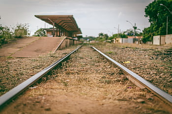 A deserted railway line leading to a rustic station in Brasília, Brazil. HD wallpaper