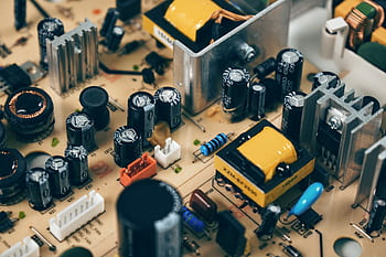 Detailed shot of capacitors and resistors on a circuit board, showcasing modern technology. HD wallpaper