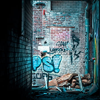 Abandoned alley showcasing vibrant graffiti on a dilapidated brick wall. HD phone wallpaper
