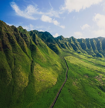 A stunning aerial view of green mountains in Hawaii, showcasing vibrant nature and lush landscapes. HD phone wallpaper