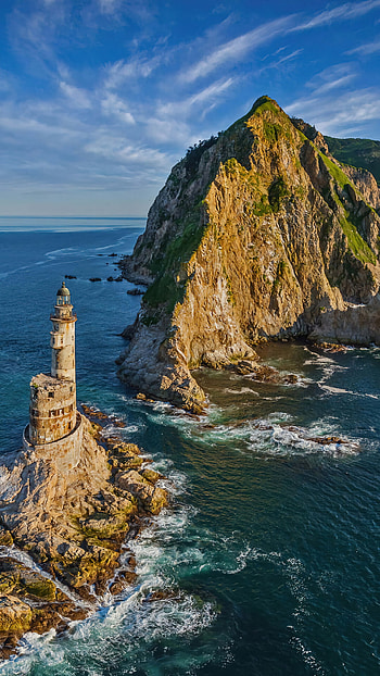 Captivating lighthouse, Island landscape, Tranquil scenery, Coastal charm HD phone wallpaper