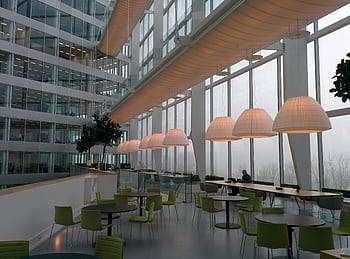 Contemporary office interior with large windows and stylish furniture, featuring a foggy exterior view. HD wallpaper
