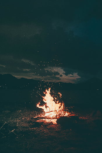 A peaceful campfire burning brightly under a starry sky in Colibița, Romania, creating a warm and cozy atmosphere. HD phone wallpaper