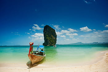 Capture the serene beauty of a Thailand beach with turquoise waters and iconic rock formations. HD wallpaper