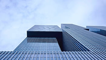 Low-angle view of a modern skyscraper in Rotterdam showcasing futuristic glass architecture. HD wallpaper