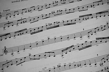 Detailed view of sheet music featuring musical notations and symbols. HD wallpaper