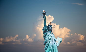 Iconic Statue of Liberty with majestic clouds in New York, USA. Perfect travel destination . HD wallpaper