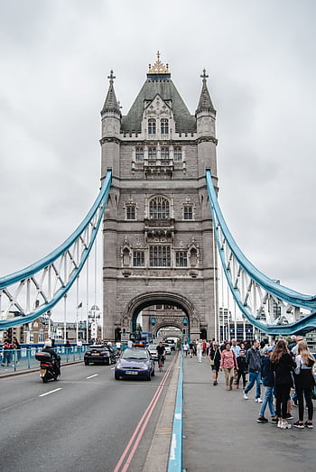 View of Tower Bridge in London, showcasing its iconic architecture and bustling scene with visitors. HD phone wallpaper