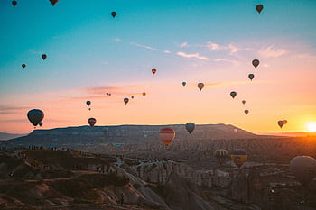Colorful hot air balloons soaring over Cappadocia at sunrise, Turkey. HD wallpaper