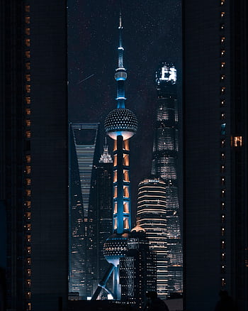 Futuristic skyscrapers of Shanghai illuminated at night, showcasing modern architectural marvels. HD phone wallpaper