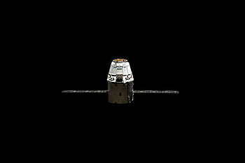 A SpaceX Dragon capsule orbited against the dark vastness of outer space. HD wallpaper