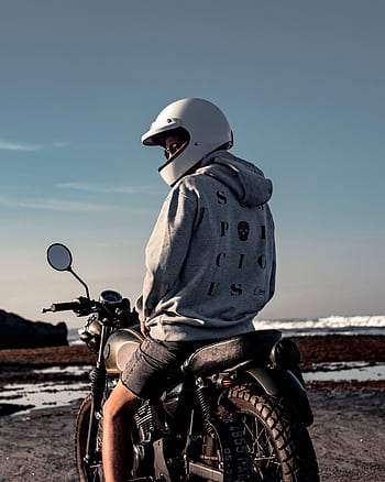 Man on a motorcycle with helmet enjoying Bali's scenic coastline. HD phone wallpaper