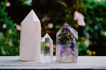 A beautiful arrangement of crystals including amethyst and quartz displayed outdoors. HD wallpaper