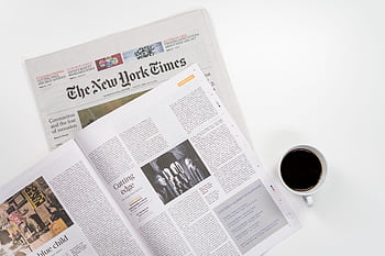 Flat lay of a coffee cup and The New York Times newspaper, ideal for business and lifestyle themes. HD wallpaper