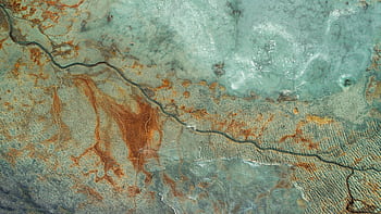 Aerial graph showcasing cracked earth with natural textures and colors in Slovenia. HD wallpaper