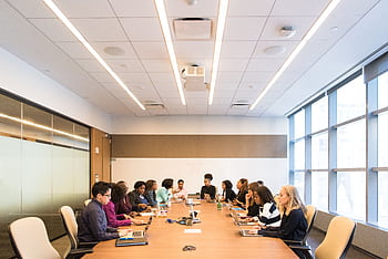 A multicultural team brainstorming and collaborating during a business meeting. HD wallpaper