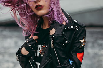 Stylish woman with purple hair in a studded leather jacket. Edgy and modern fashion. HD wallpaper