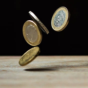 Dynamic shot of euro coins appearing to float, symbolizing active economy. HD phone wallpaper