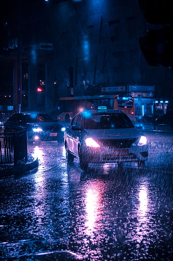 Urban street at night with cars in heavy rain, reflecting neon lights. HD phone wallpaper