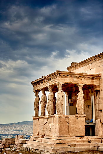 View of the Erechtheion Temple's Caryatids on the Acropolis in Athens, Greece, against a dramatic sky. HD phone wallpaper