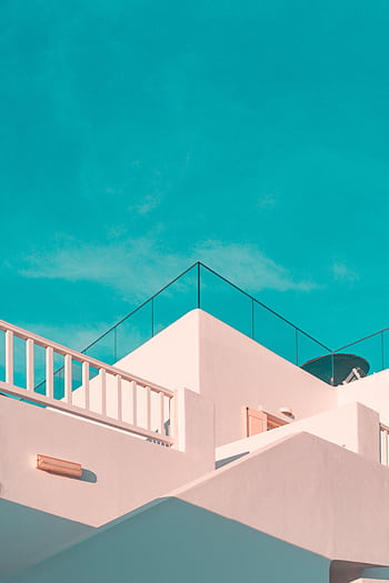 Explore the clean lines of modern Cycladic architecture under a clear blue sky in Platis Gialos, Greece. HD phone wallpaper