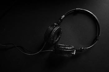 Minimalist black heads on a dark textured background, ideal for audio and music design themes. HD wallpaper